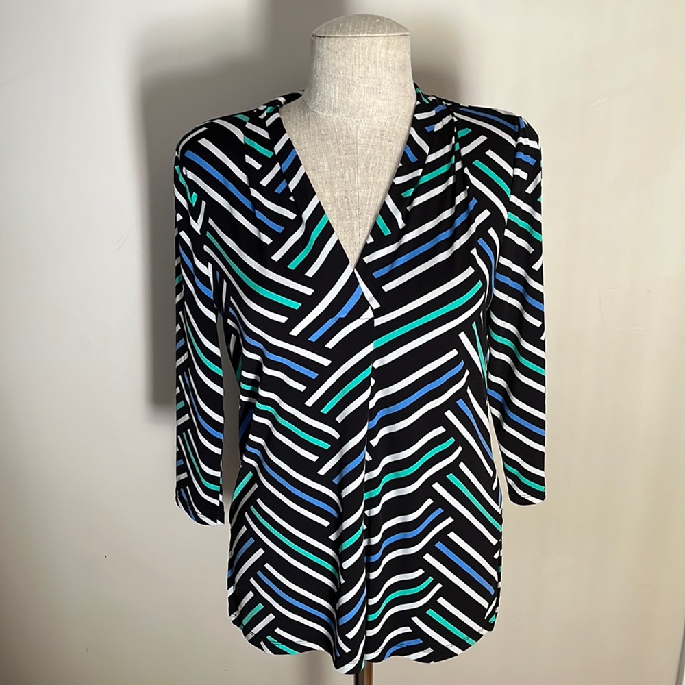 Blouse with black, white, green, and blue print.